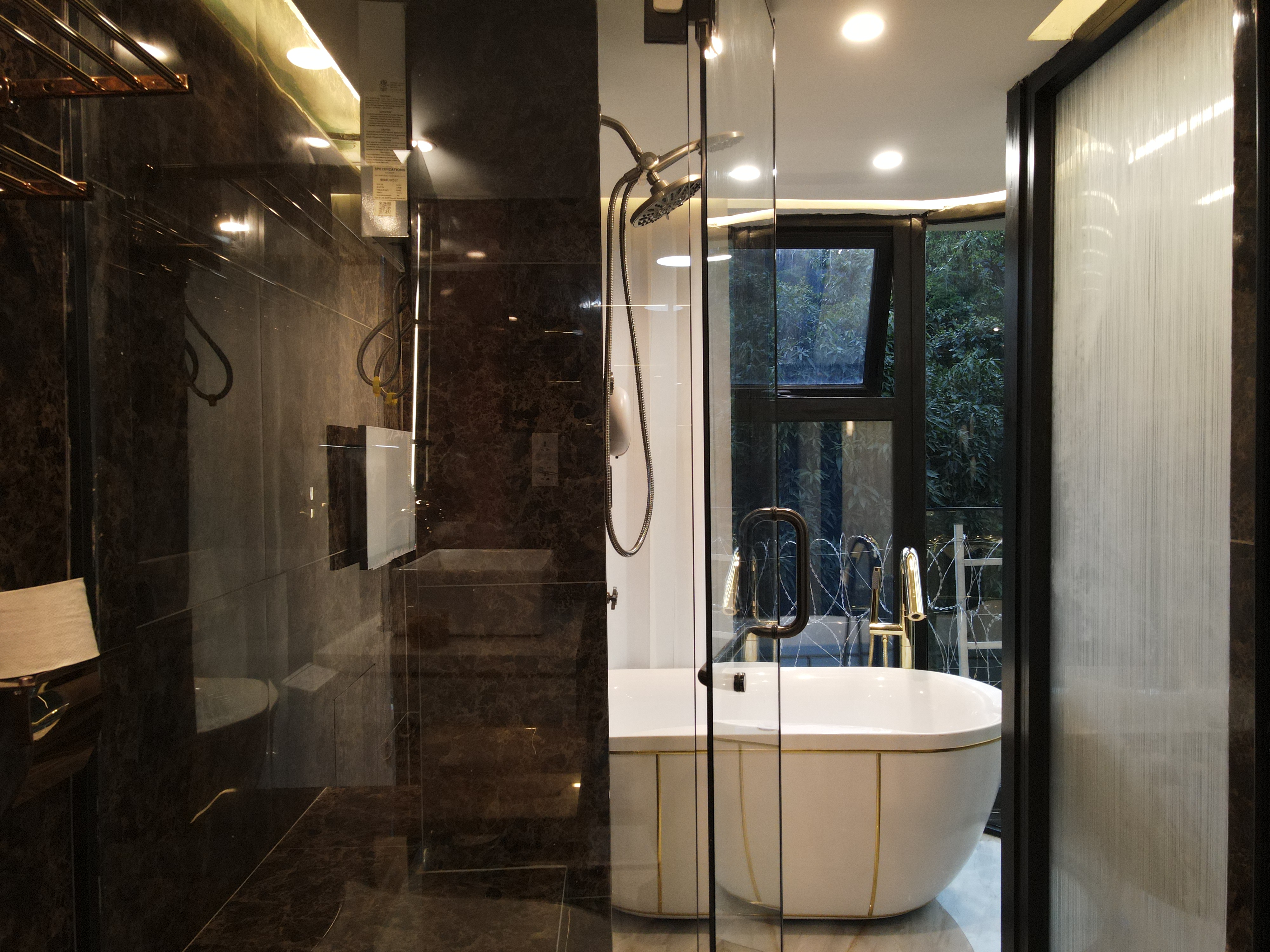 Dark marble bathroom with gold accents and luxury fixtures