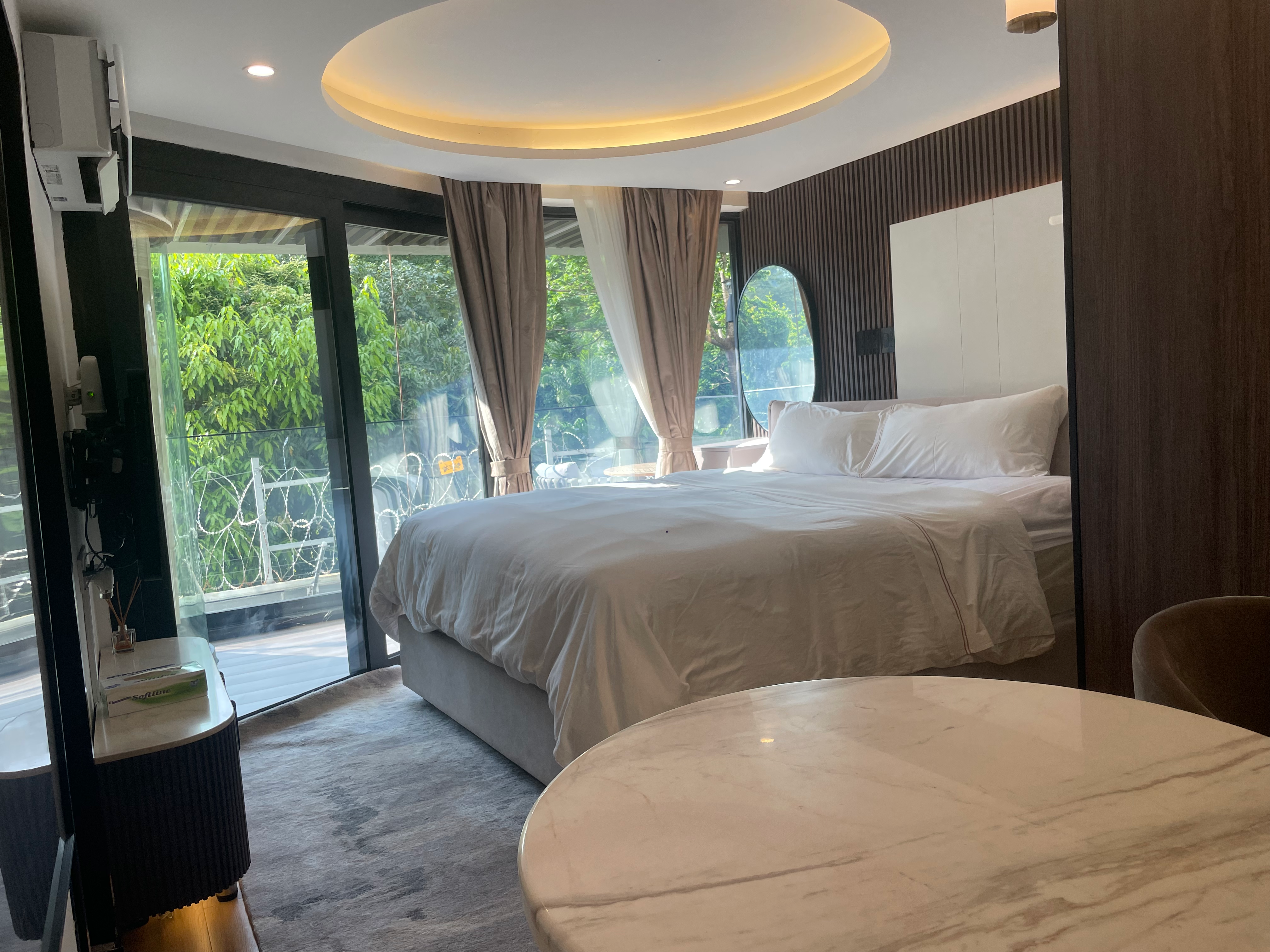 Bedroom with warm evening lighting and ottoman detail