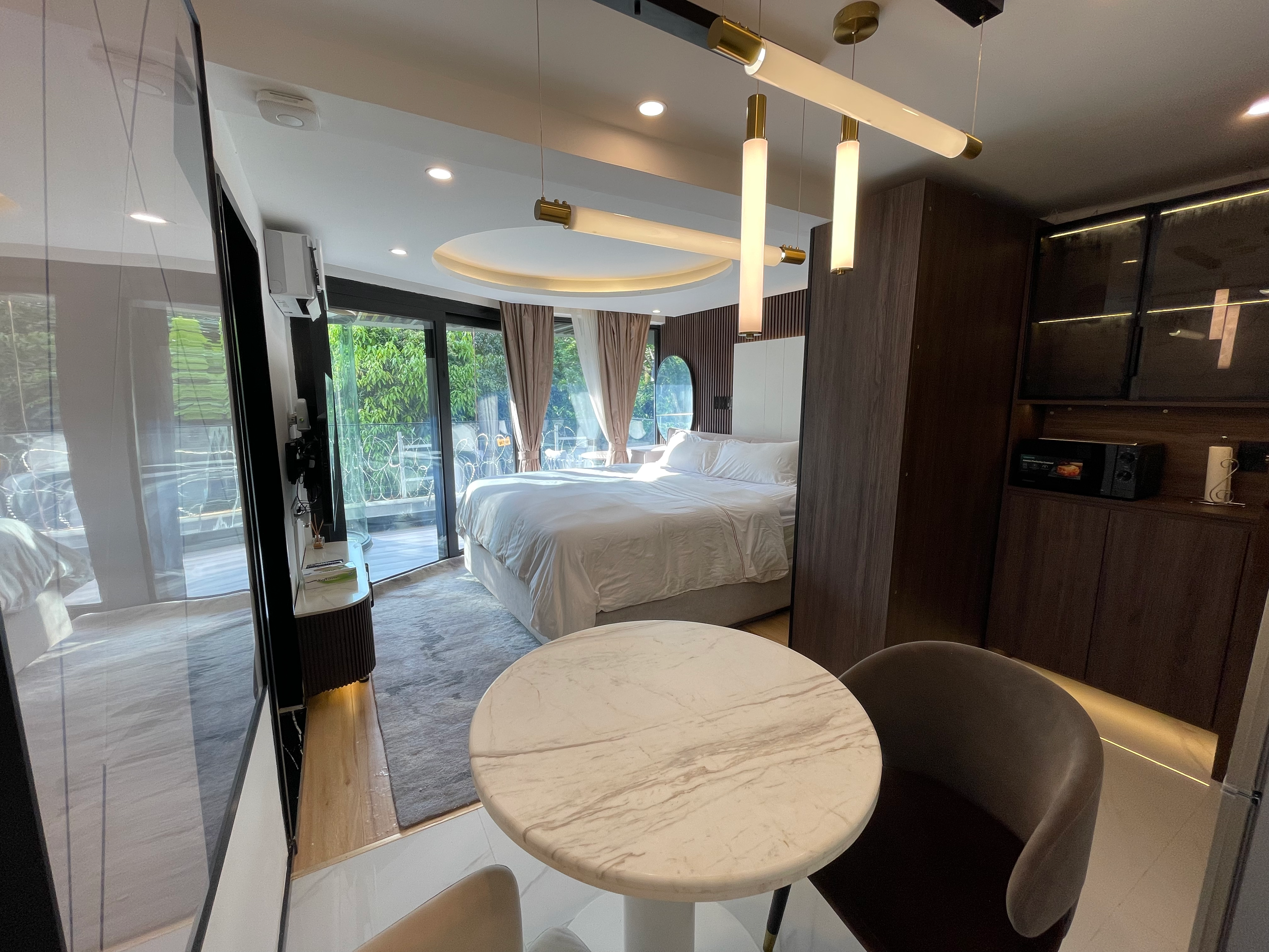 Full suite view with dining area and warm evening ambiance