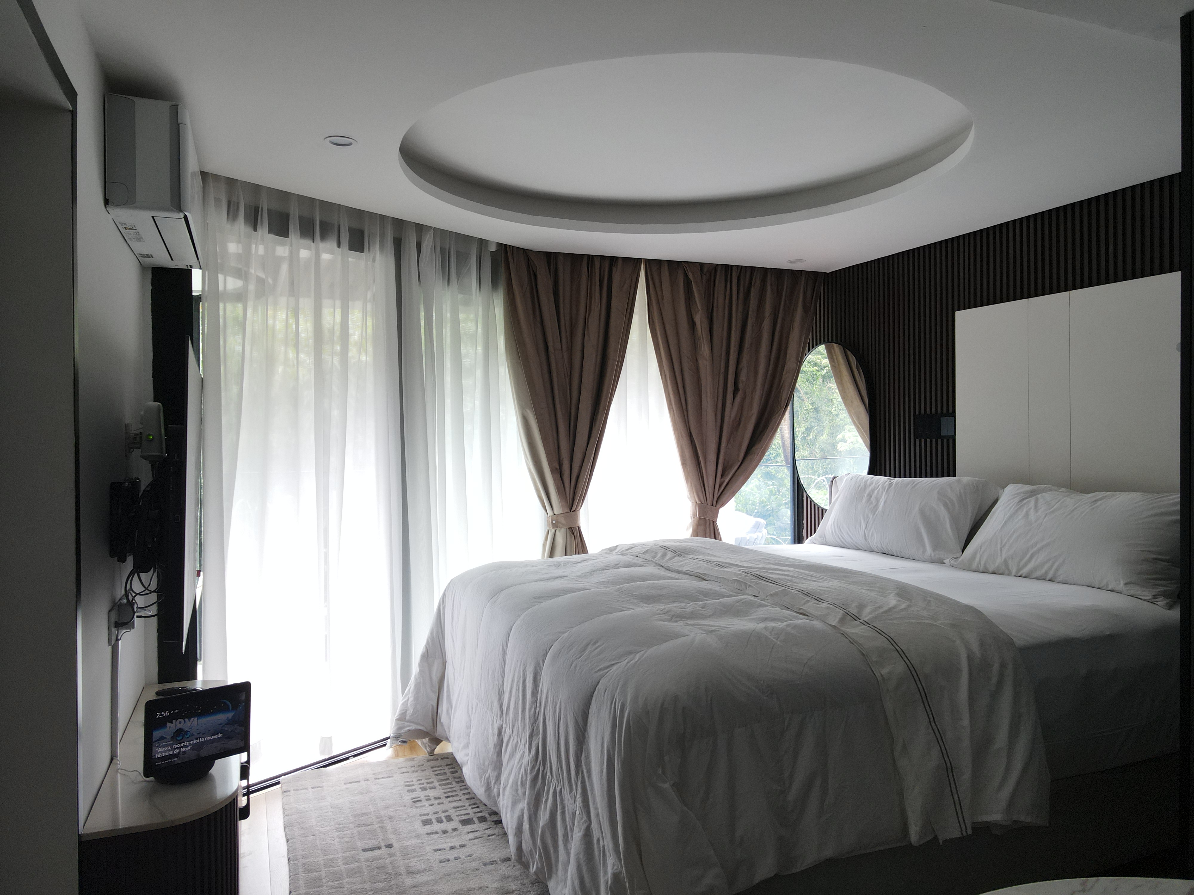 Bright daytime bedroom with natural light and forest view