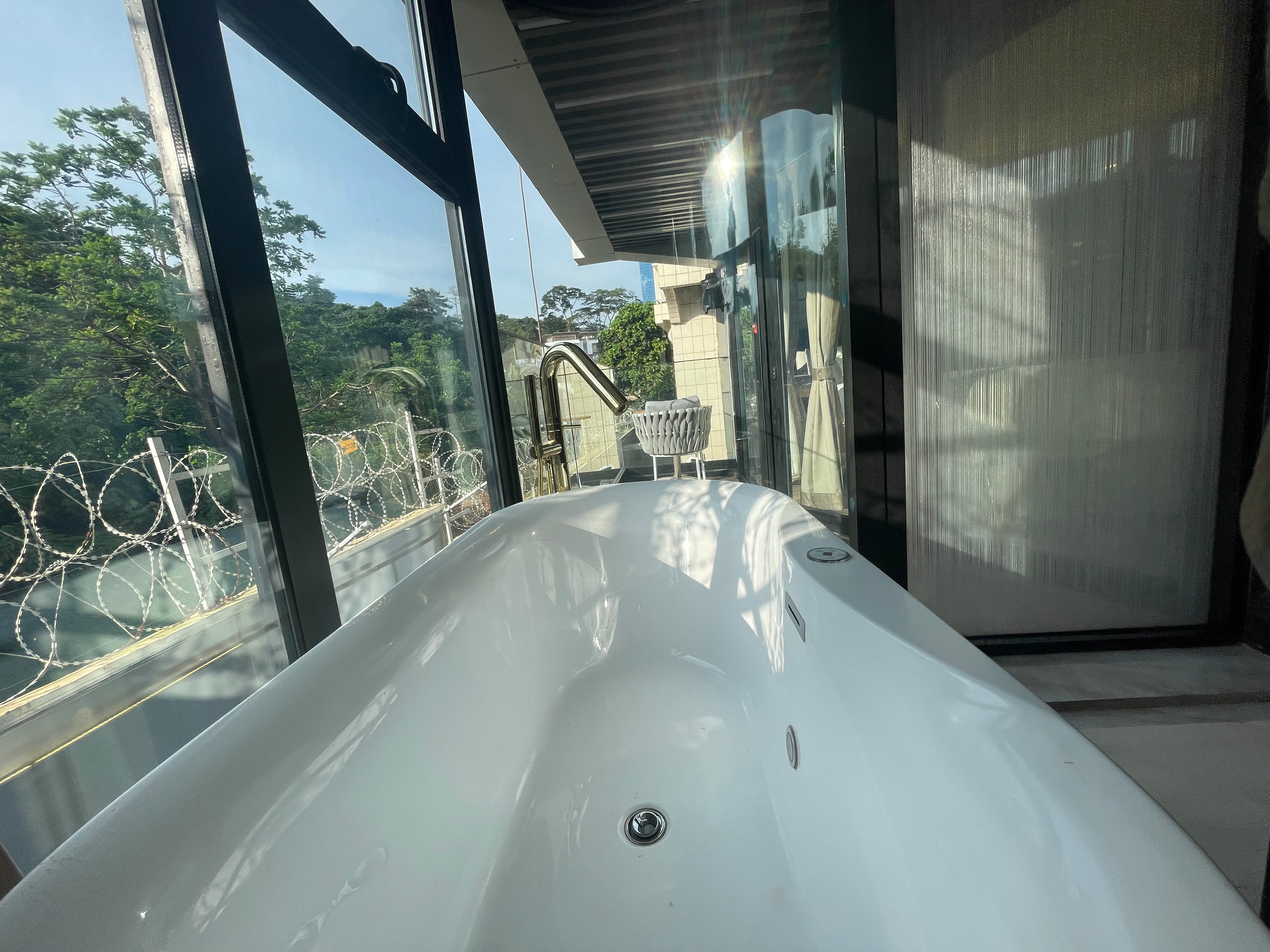 Wide angle bathtub view with balcony access