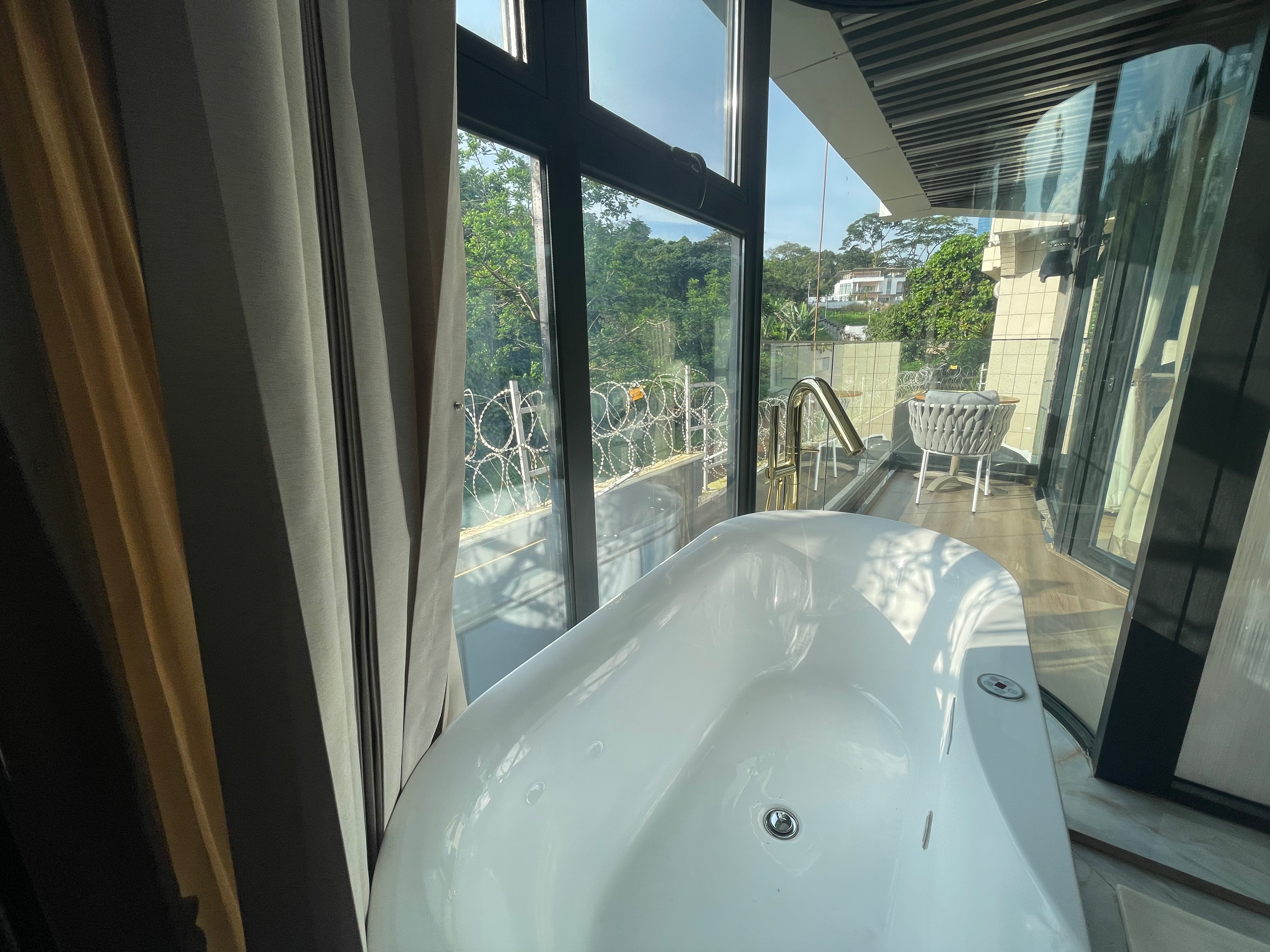 Elegant bathtub with sheer curtains for privacy and natural light